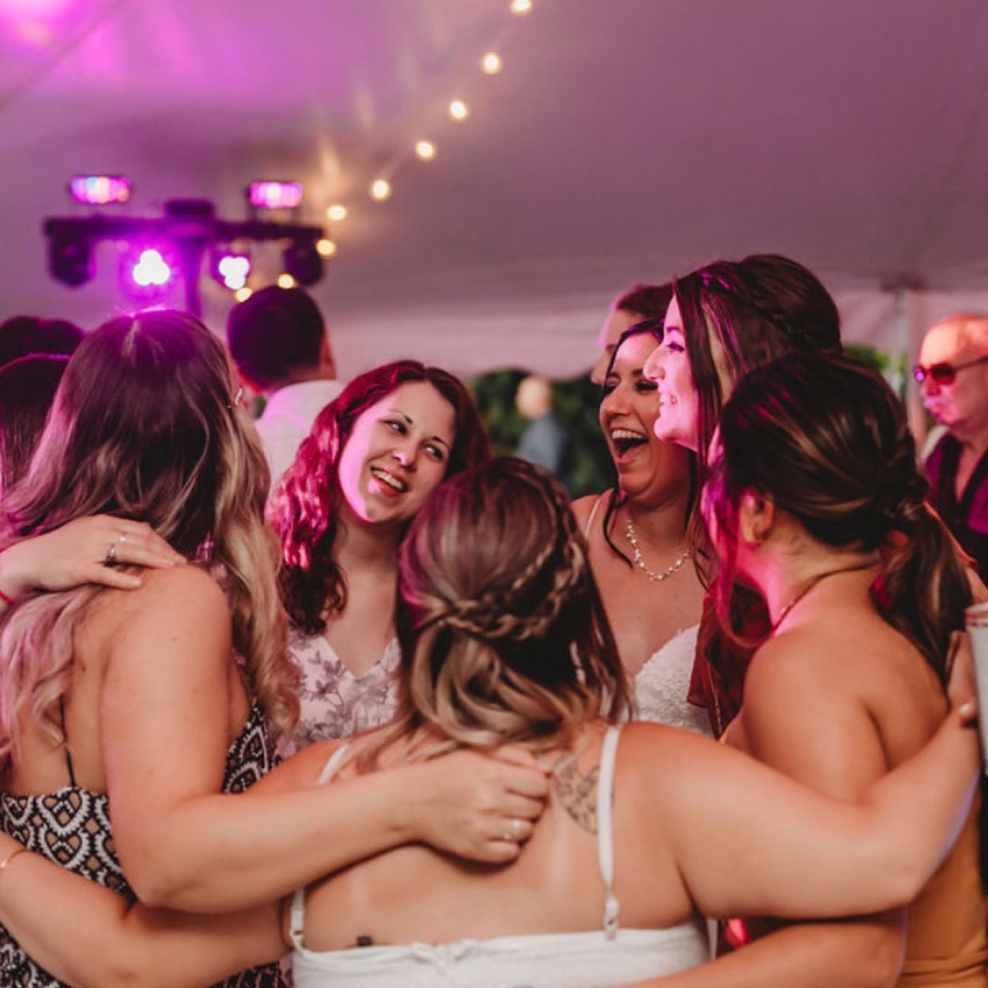 Bridesmaids hugging and singing along
